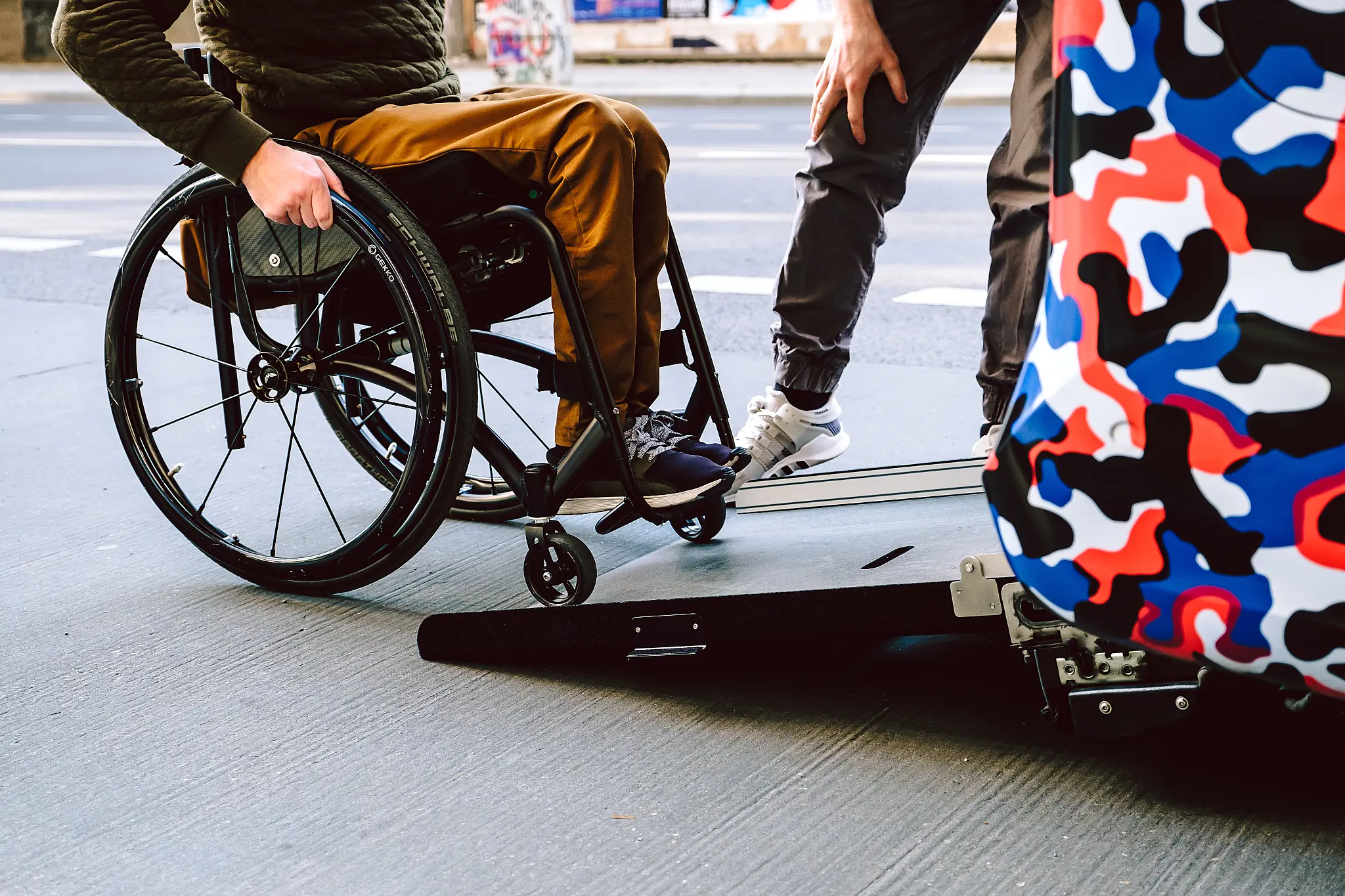 a person in a wheelchair using a van's ramp